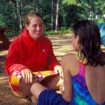 camp counselor talking to girl