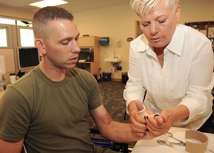 occupational therapist helping patient
