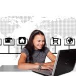 woman working on laptop with a modern background behind her