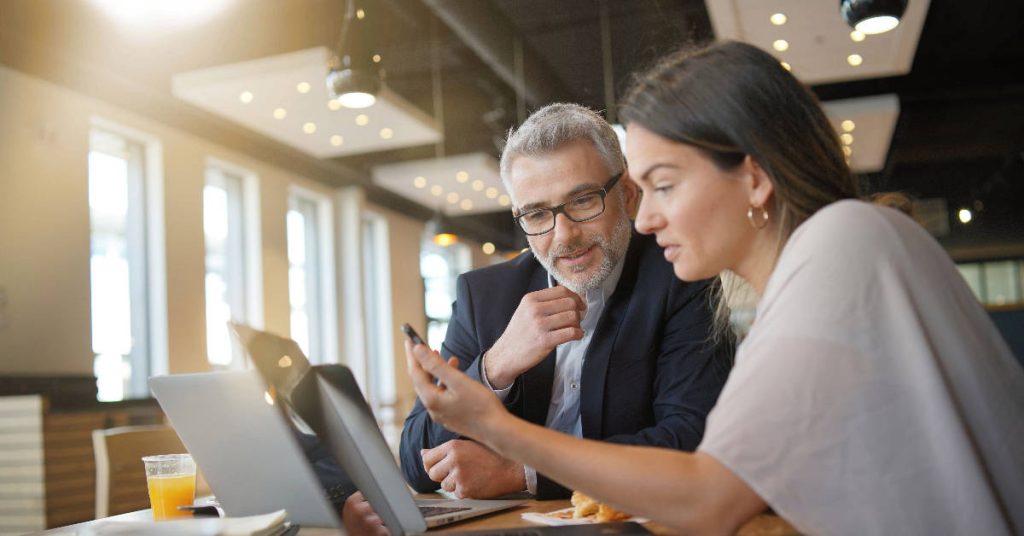 An employee explaining a new project to brand ambassador of the company